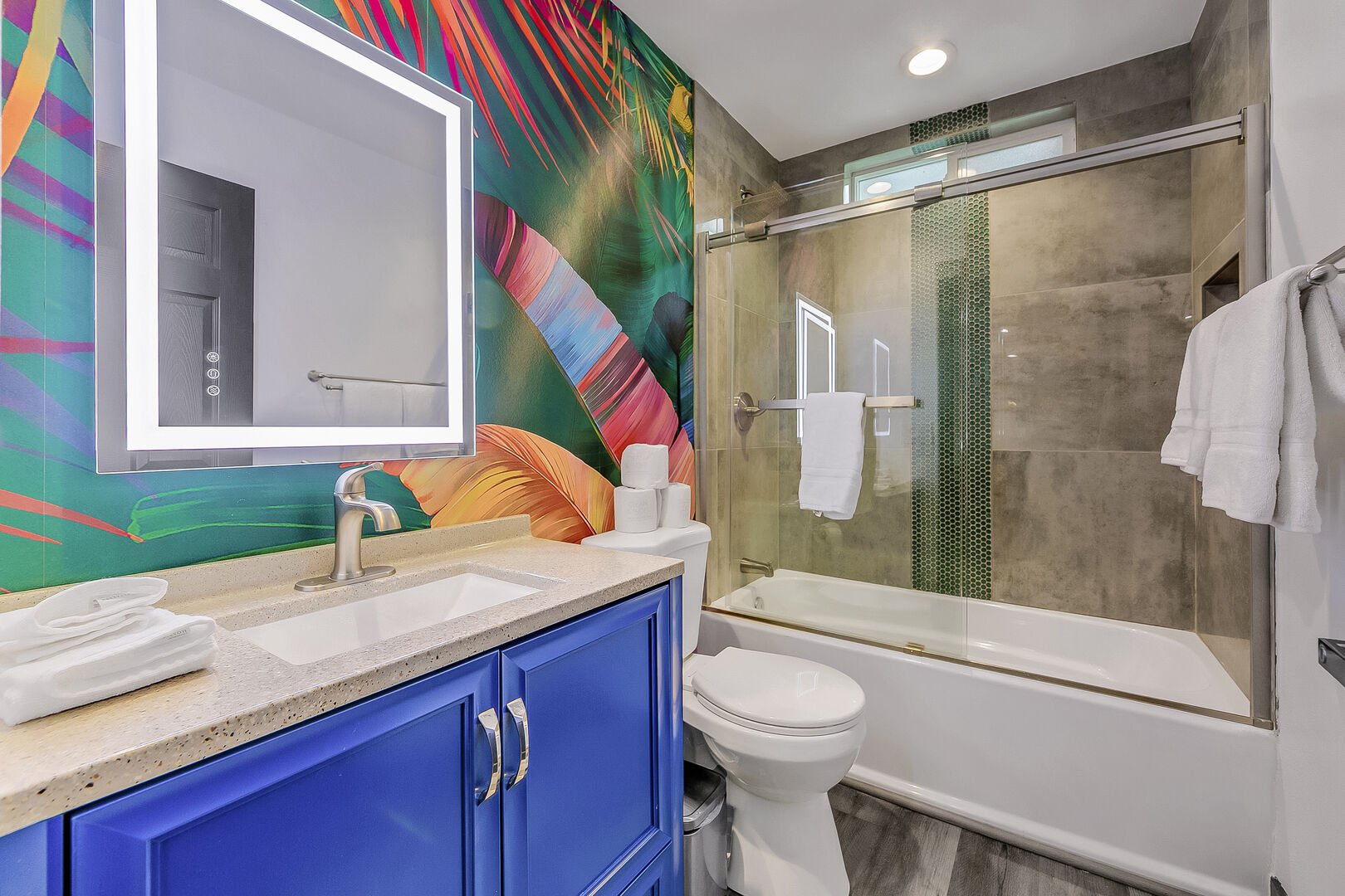 The private, en suite bathroom features a bathtub and shower combo, along with a vanity sink.