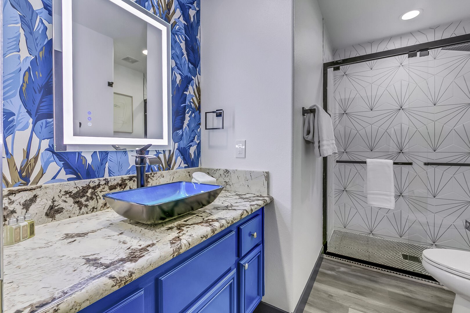 Hallway Bathroom 4 is located next to Bedroom 4 and features a a tile shower and decorative vanity sink.