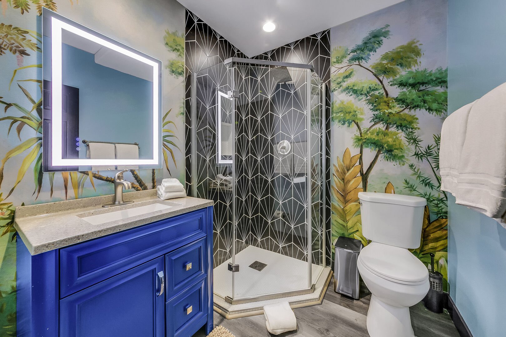 The private, en suite bathroom features a tile shower and a decorative vanity sink.