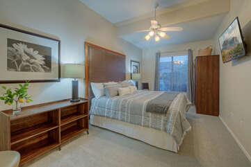 The sixth bedroom on the first floor has the standard features of a king bed, ceiling fan and TV.