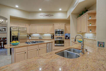Modern kitchen has new appliances and granite counters.