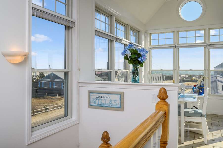 view from top of stairs over looking dining area with grand ocean views.27 Fiddlers Green Lane-Dennis Port-New England Vacation Rentals
