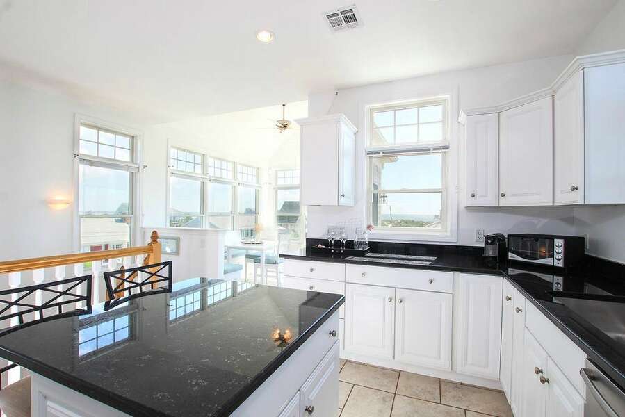 Modern open concept kitchen and dining area with views of the ocean 27 Fiddlers Green Lane-Dennis Port-New England Vacation Rentals