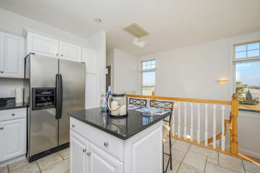 Open concept Kitchen with center island and stairs to lovwer level.27 Fiddlers Green Lane-Dennis Port-New England Vacation Rentals