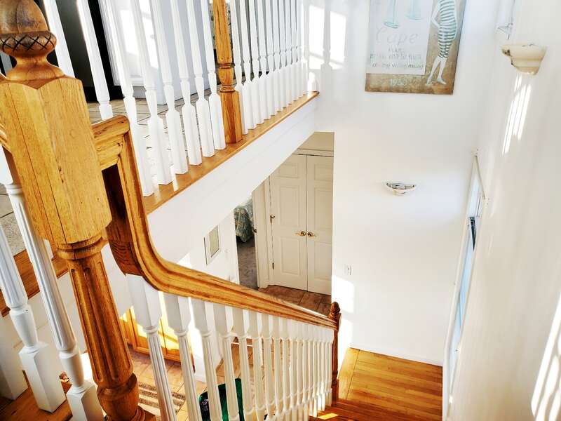 Looking down the stairs to the first floor. 27 Fiddlers Green Lane-Dennis Port-New England Vacation Rentals