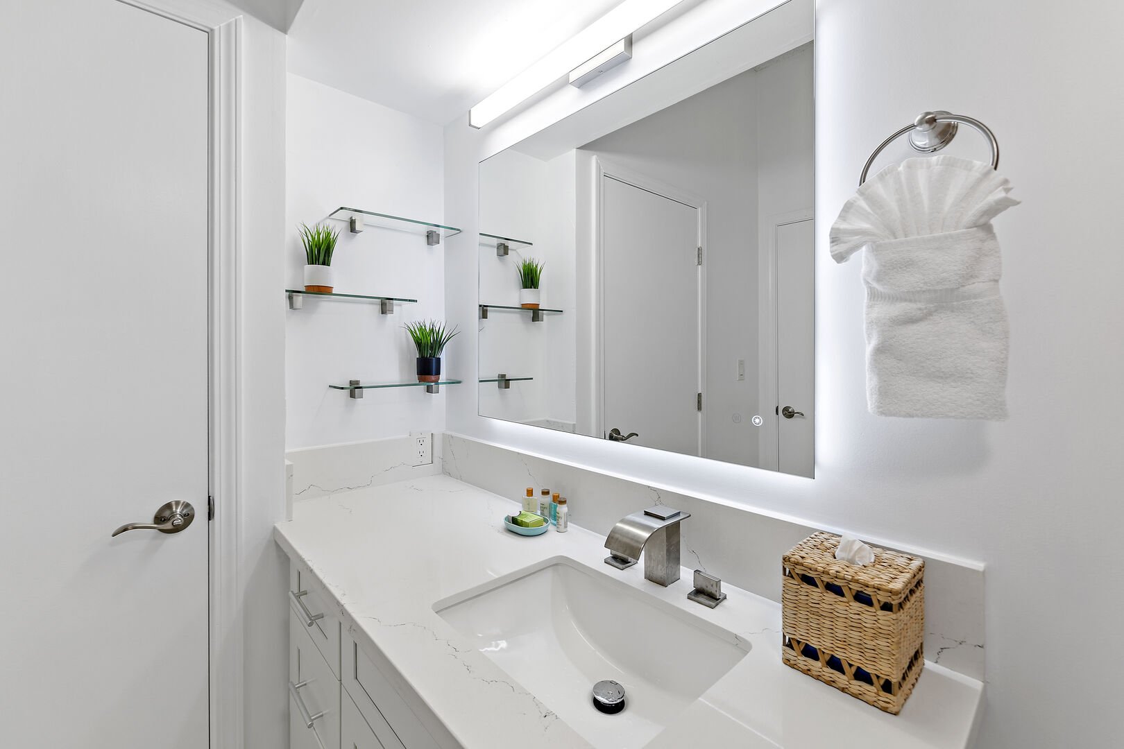 Well-lit bathroom with plenty of storage space for toiletries