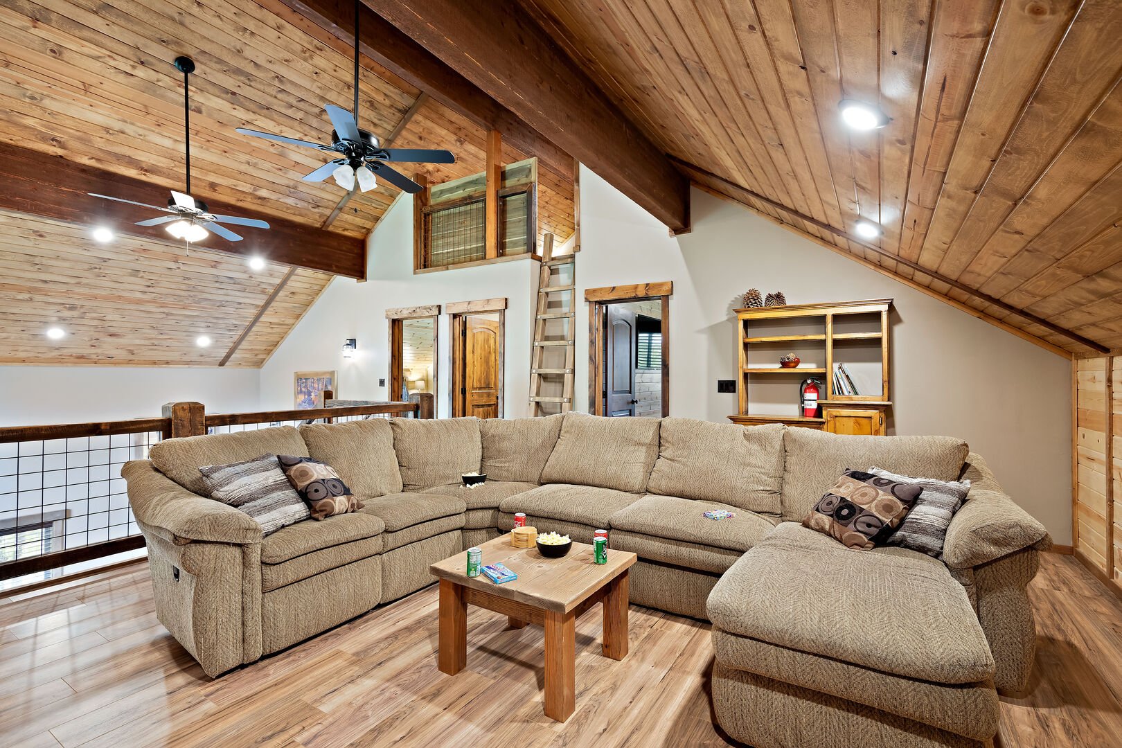 Set the Hook ~ upper level living room w/ sleeper sofa sectional (ladder in back is only access to LOFT bedroom #5)