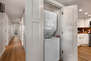 Stackable washer/dryer unit off of kitchen