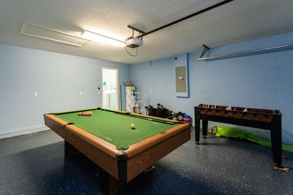 Pool table and foosball in garage games room