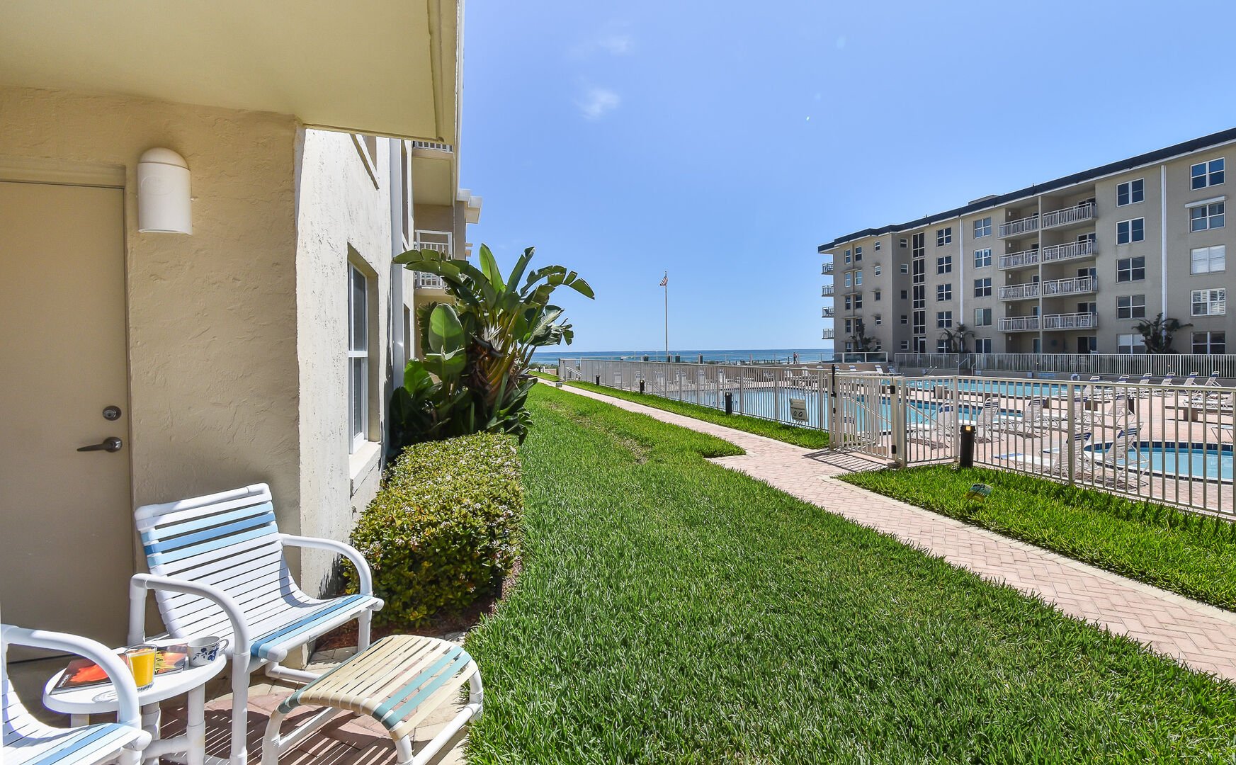 View of the pool from the patio in our Sea Coast Gardens II #111 condo