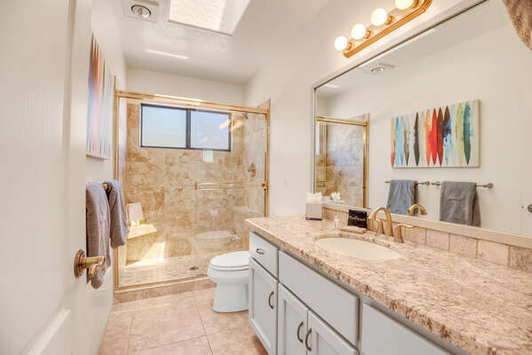 Full Shared Bath with a Granite Counter Sink and Tile/Glass Shower
