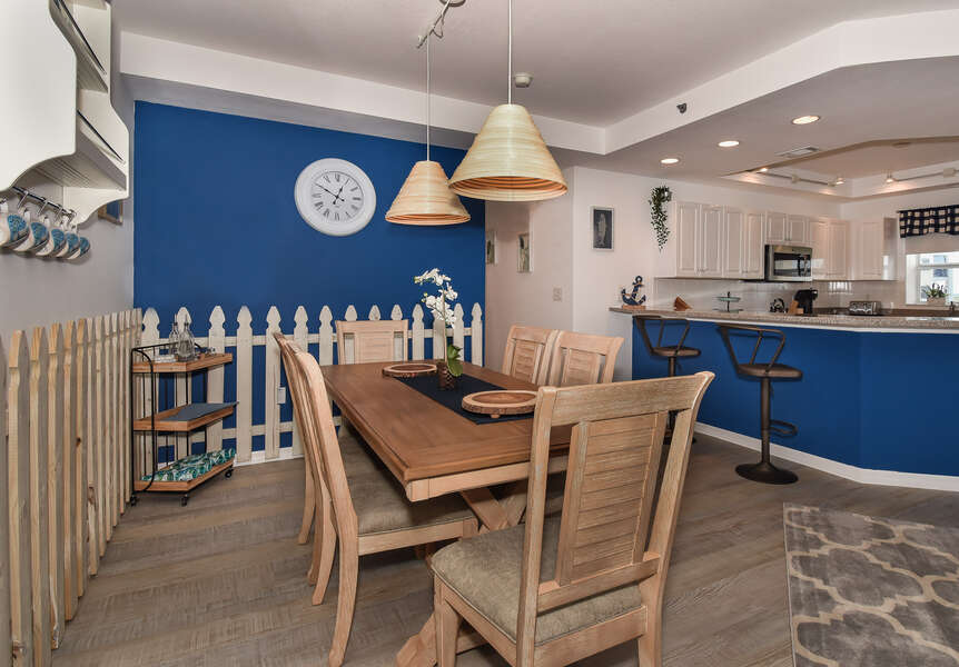 Dining table, chairs, and the breakfast bar with seating for two