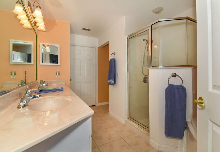 Bathroom with his and her sinks, and walk-in shower