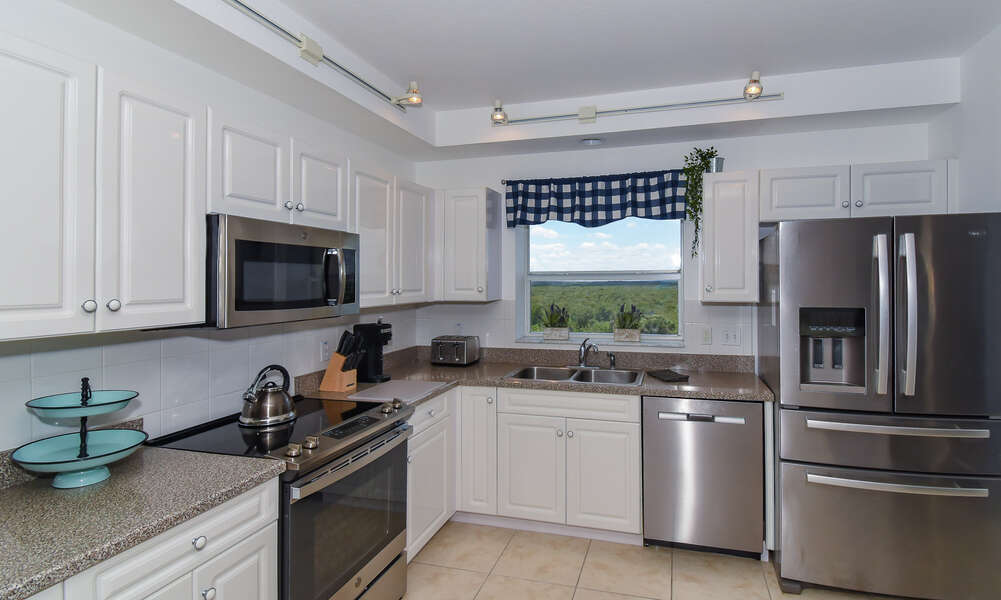 Kitchen with dishwasher, refrigerator, microwave, and toaster