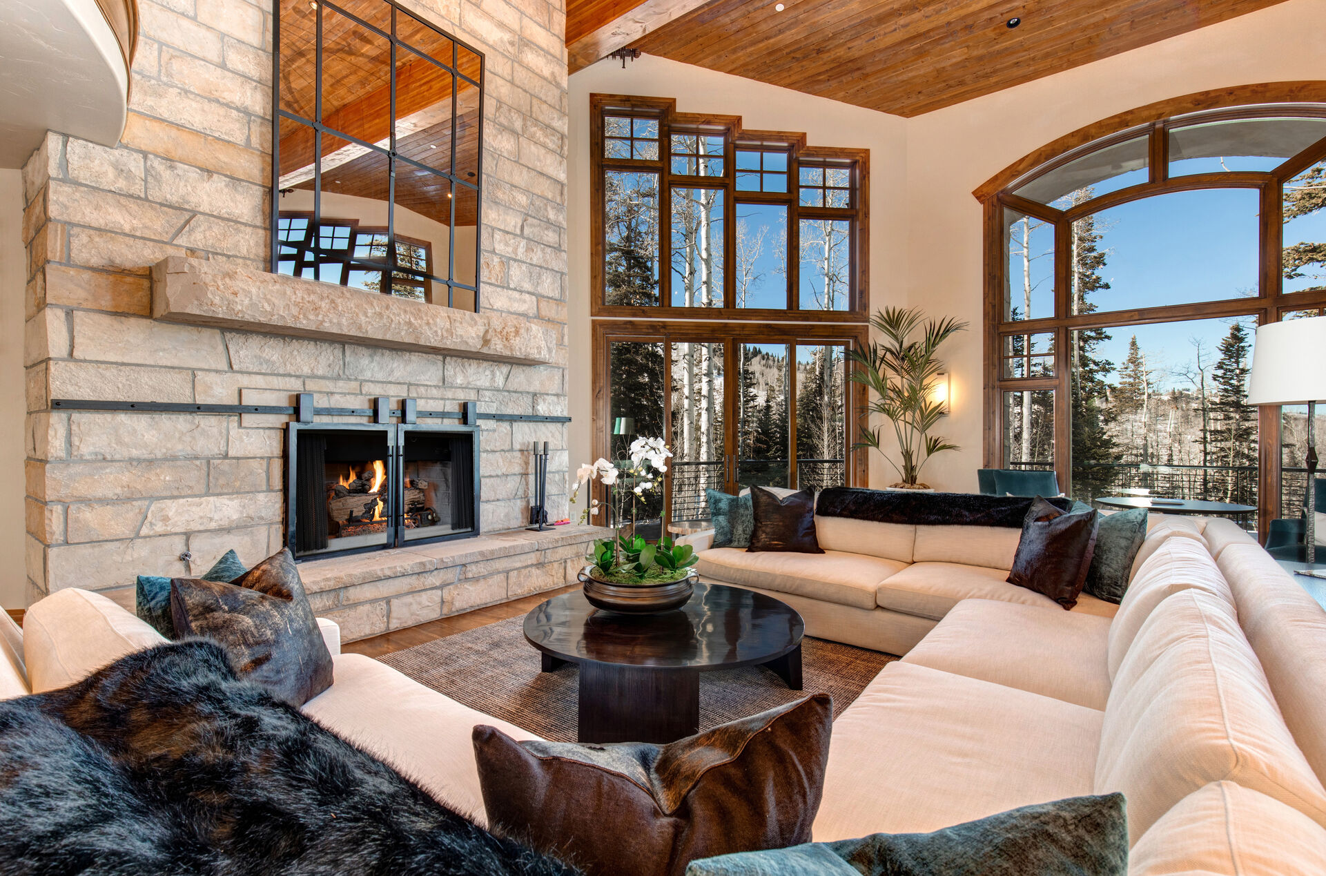 Enormous Upper Living Room with three separate sitting areas. This room provides ample seating, large wood-burning fireplace, and private, recently remodeled, sun-deck access