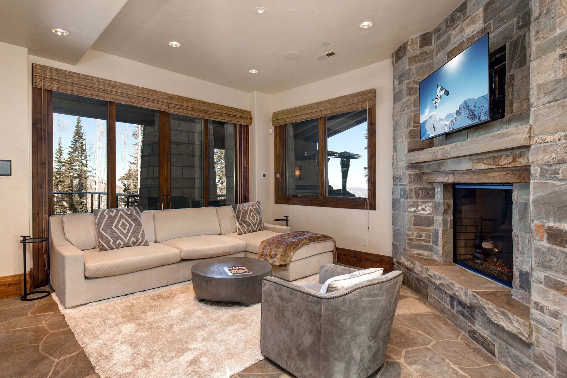 Enter this sprawling home through the garage and into the ski locker and lounge area with 6 ski lockers, hot tub patio access, gas fireplace, sectional sofa and 55