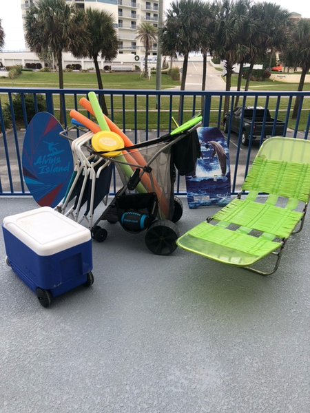 A beach pull buggy, a beach chair, an Igloo cooler