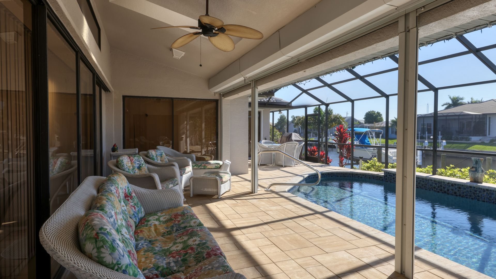 Gorgeous covered seating space to truly enjoy the outdoors overlooking the canal and pool. Enclosed lanai