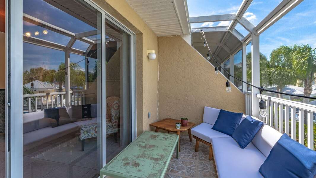 Private Patio with screened-in enclosure off the living room overlooking the docks and pools in the community