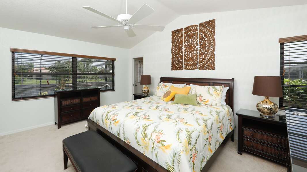 Master Bedroom  overlooks the canal and pool. Private patio door access to the pool and additional half-bath access to the pool area