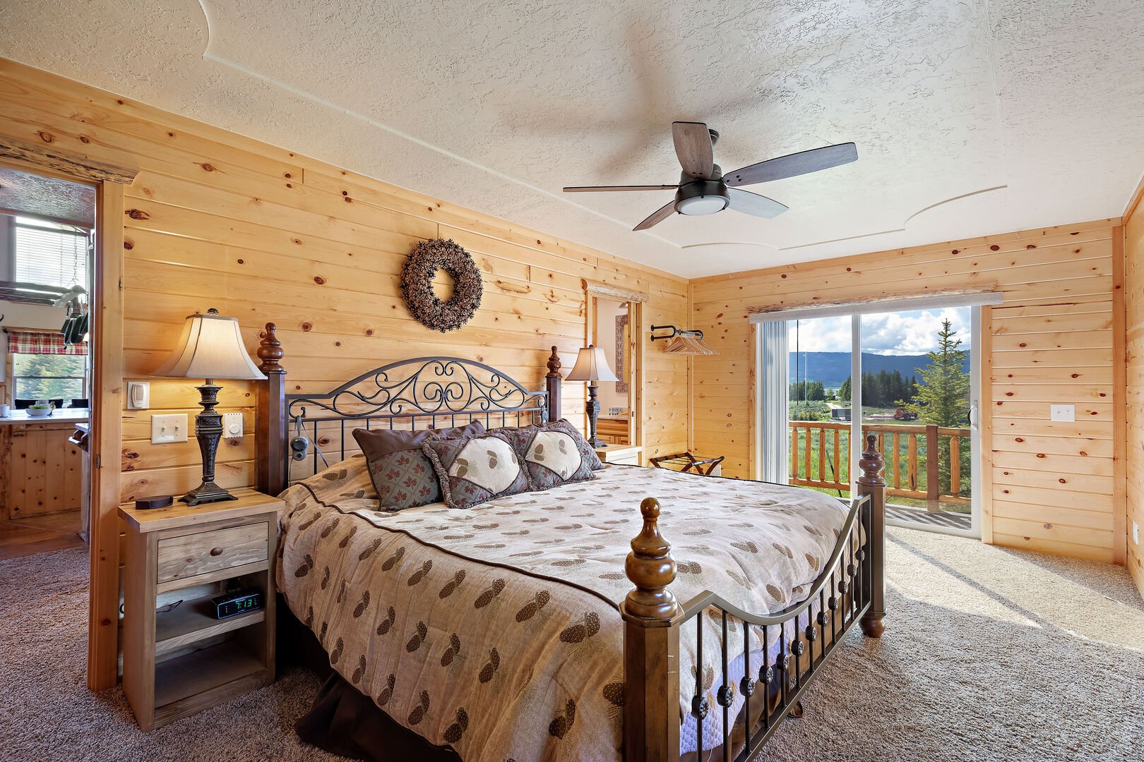 Henrys Hawk ~ main level master bedroom w/ queen bed, private ensuite bathroom, and private entrance to wraparound porch