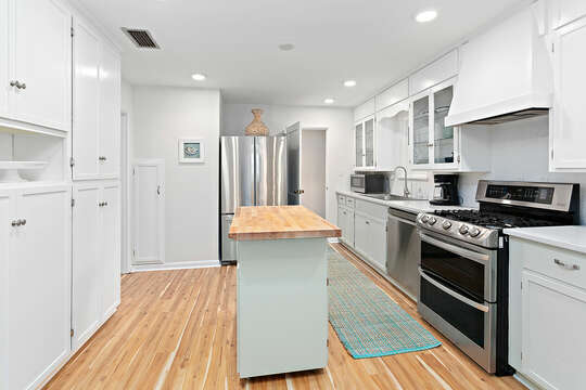 The Kitchen has stainless steel appliances and bright, white cabinets.