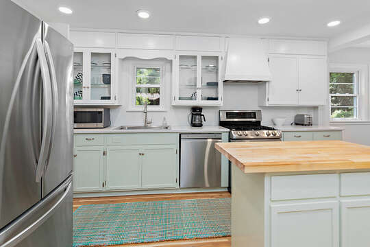The Kitchen has stainless steel appliances and bright, white cabinets.