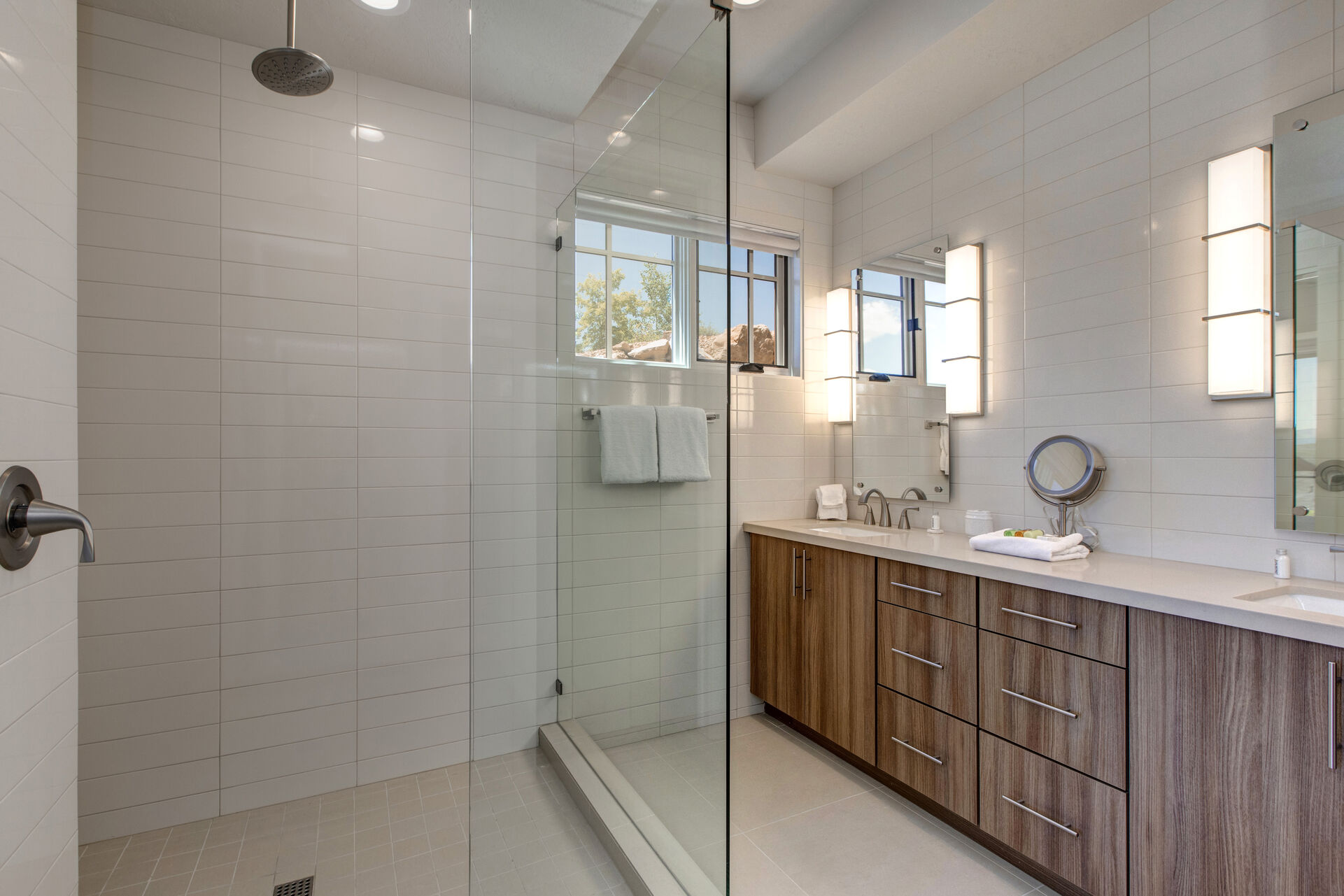 Master bathroom with large tiled shower, dual sinks, separate wash closet, and walk-in closet