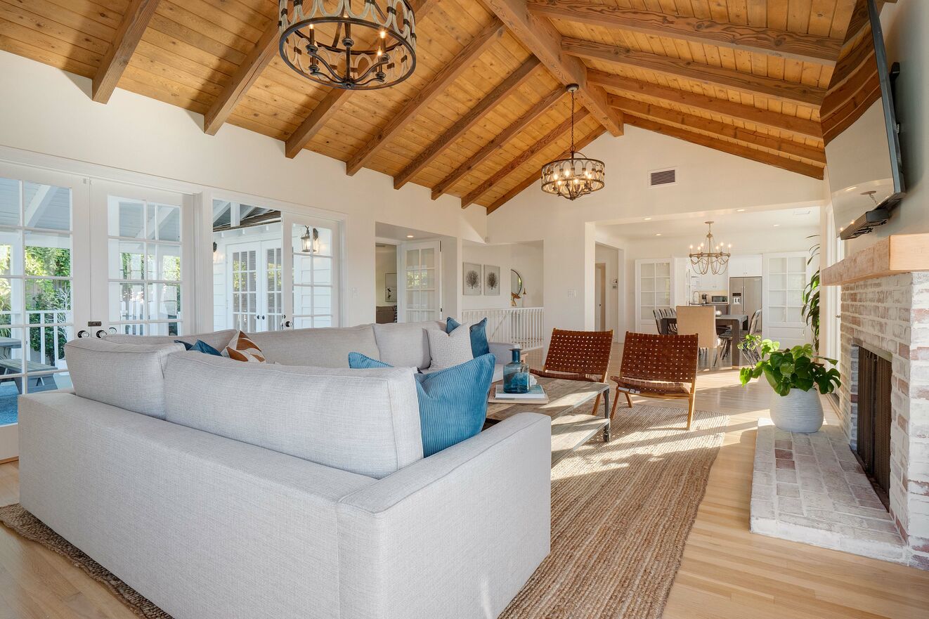 Living room with fireplace and ocean views with doors out to massive deck and patio areas