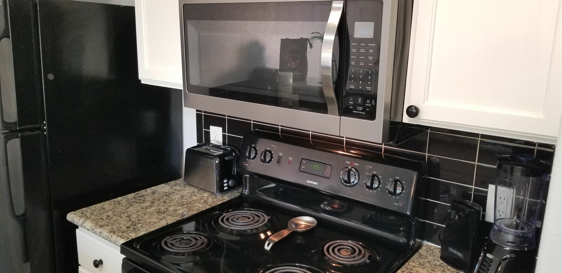 The condo offers a full-size electric stove and oven, microwave, and full-size refrigerator.