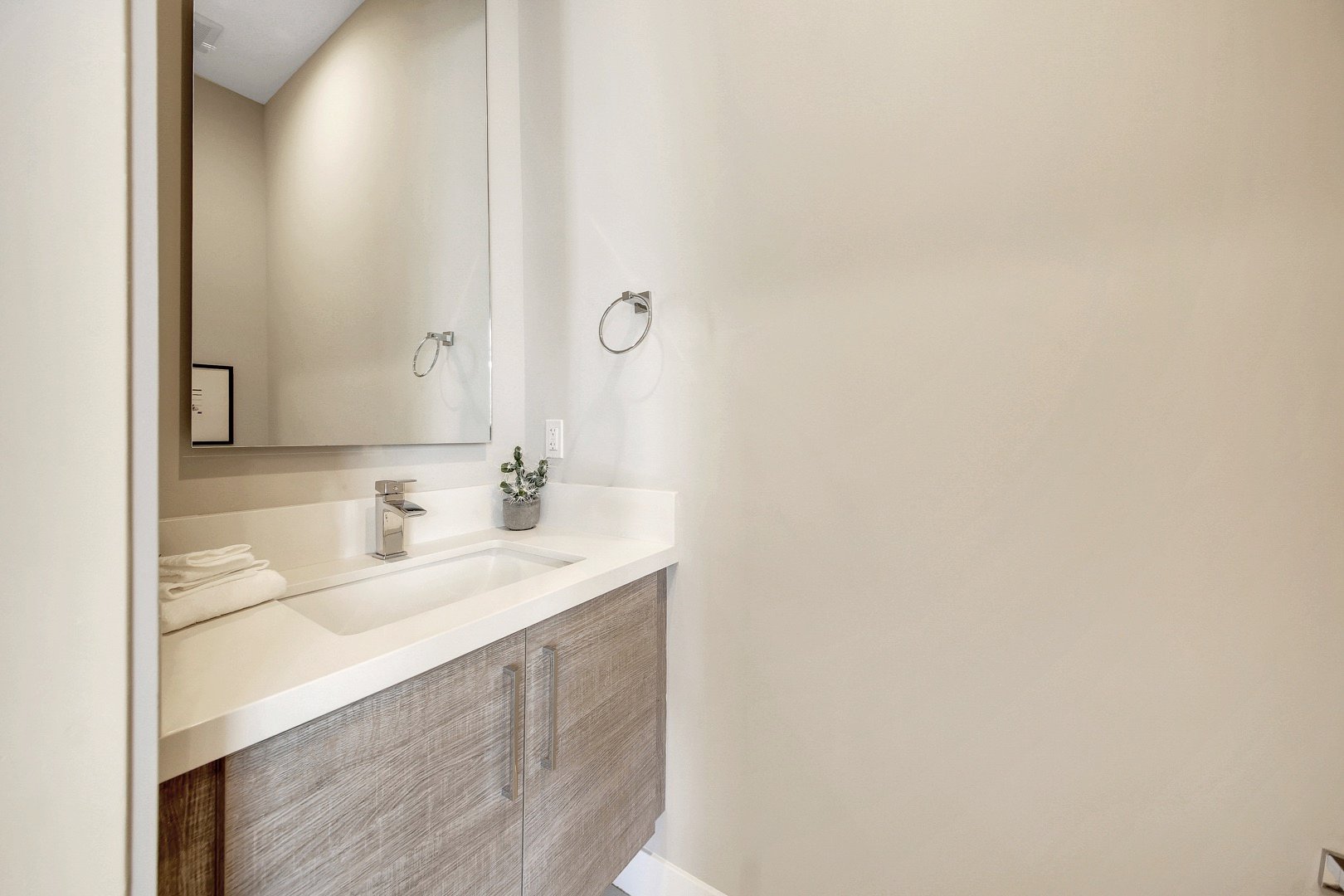 The powder room is located between bedrooms 2 and 3 and features a vanity sink.
