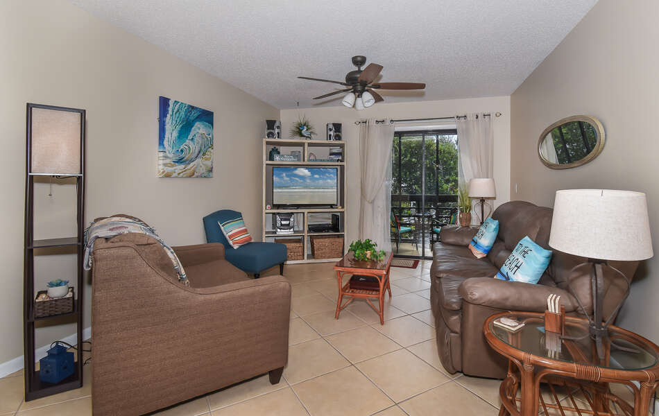 The living room features a flat screen Smart TV, Stereo/CD player, twin sofa sleeper and cozy sofa.