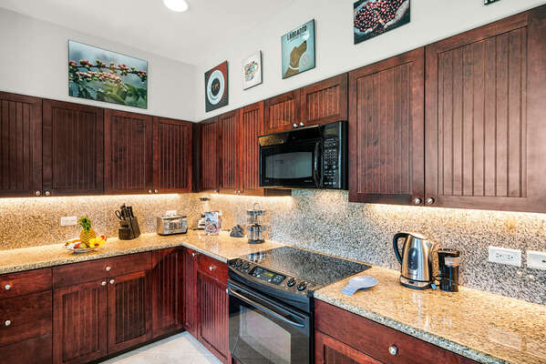 Fully Equipped Kitchen with Granite Counter Tops and Dark Wood Cabinets