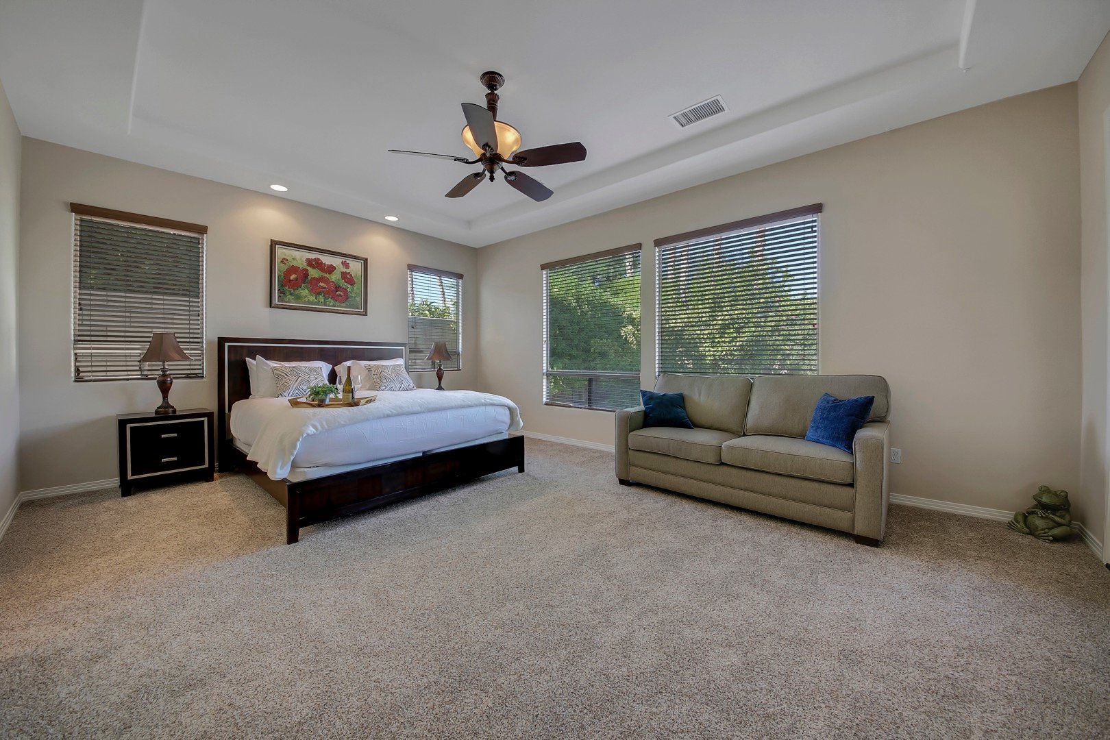 Master Suite 1 features a Cal King-sized Bed, Full-sized Sofa Sleeper, and access to the back patio.