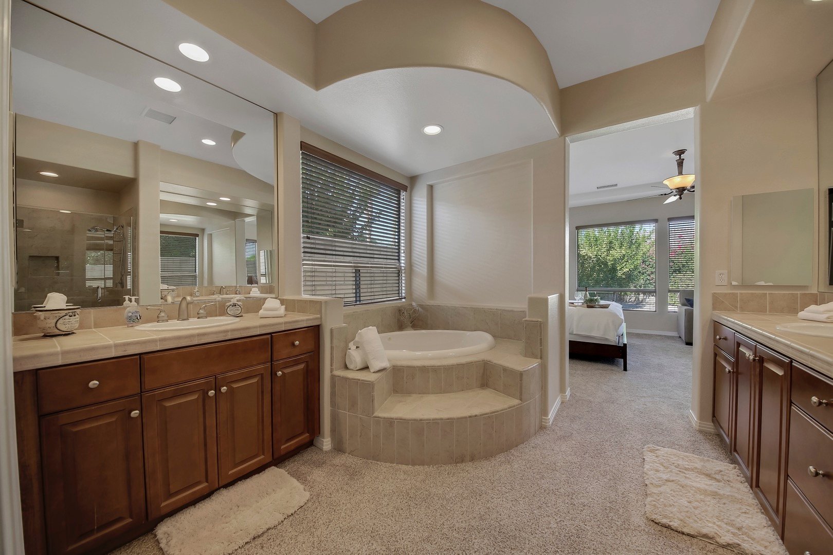 Master Suite 1 bathroom features a jacuzzi tub, tile shower, and two vanity sinks.