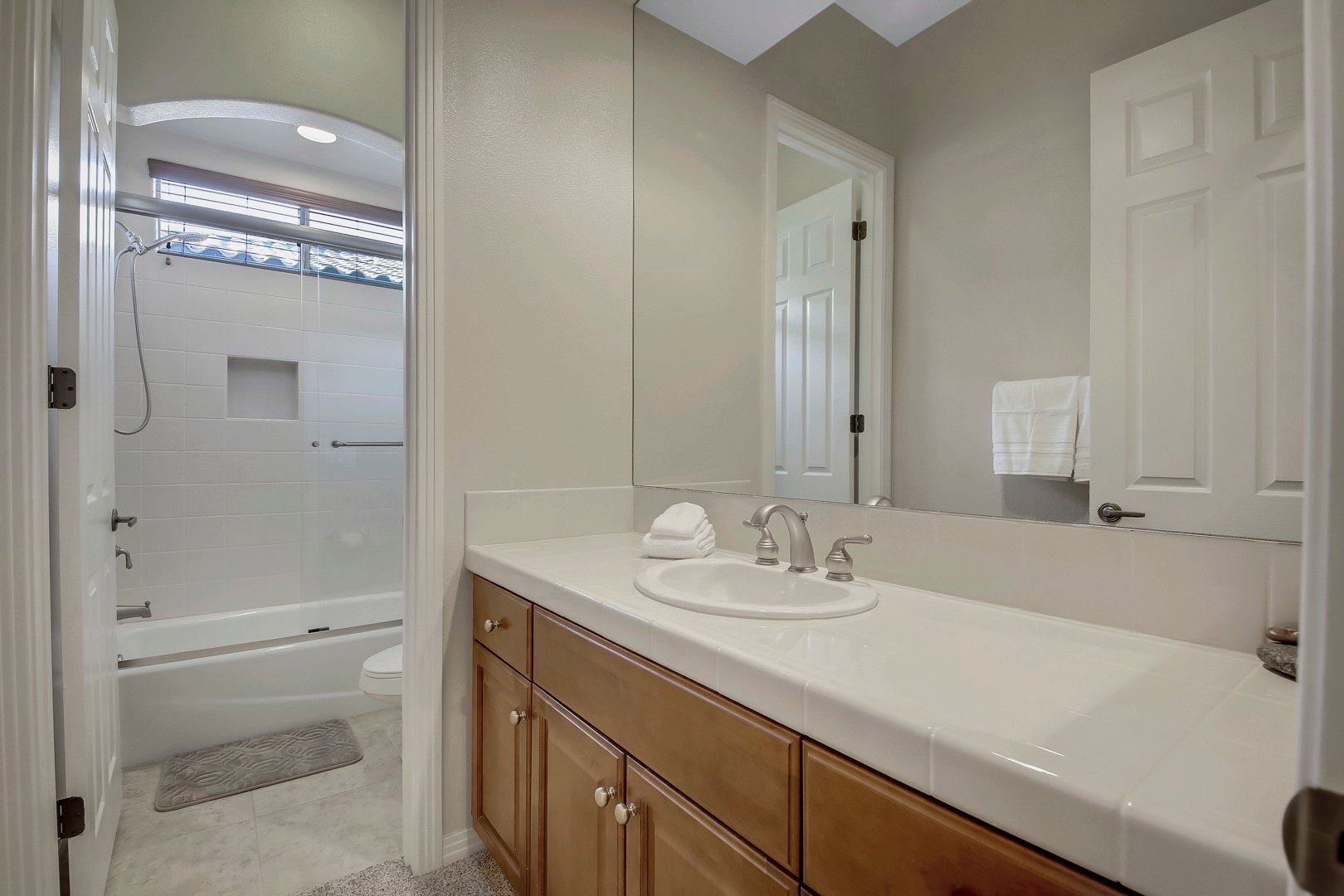 The hallway bathroom is located next to Suite 2 and features a combo shower/tub.
