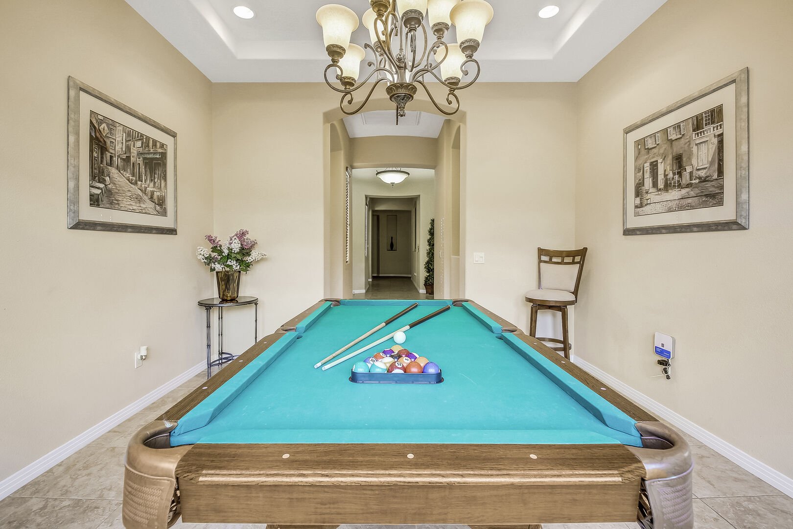 A pool table is waiting for you to play a few rounds of 8-Ball.