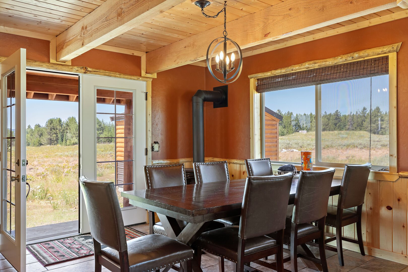 Shotgun Sunset ~ large dining table and french doors