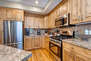 Fully Equipped Kitchen with island seating for two, gorgeous stone countertops, and stainless steel samsung appliances