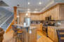 Fully Equipped Kitchen with island seating for two, gorgeous stone countertops, and stainless steel samsung appliances