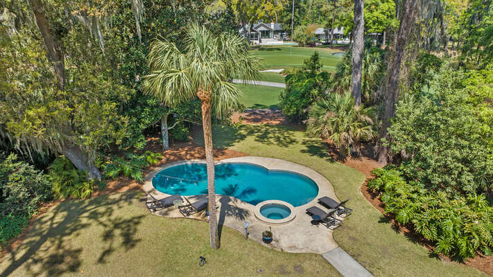 Overhead shot of the large private pool and spa with views of the golf course