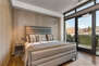 Master Bedroom with a King Bed and Private Patio Overlooking Main Street