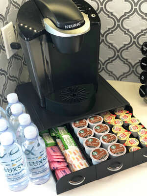 Fully stocked coffee bar including Starbucks K-cups, sweeteners, sugar and cream!