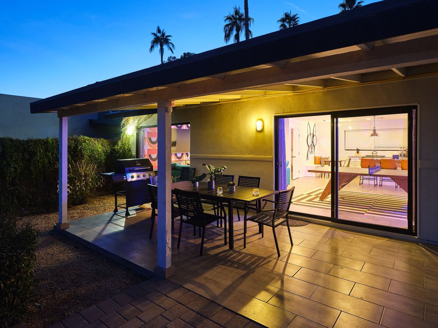 Covered outdoor patio with outdoor dining and BBQ grill.