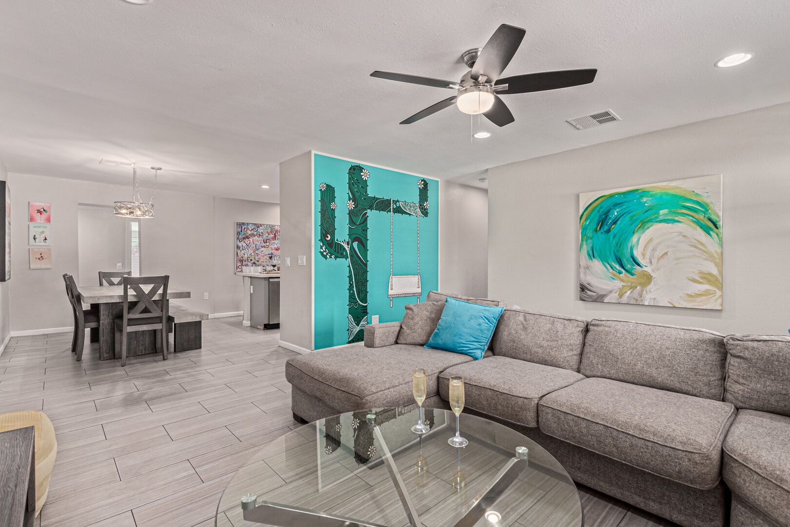 Bright Living Space featuring new mural, SMART flat-screen TV, and Designer Furnishings.