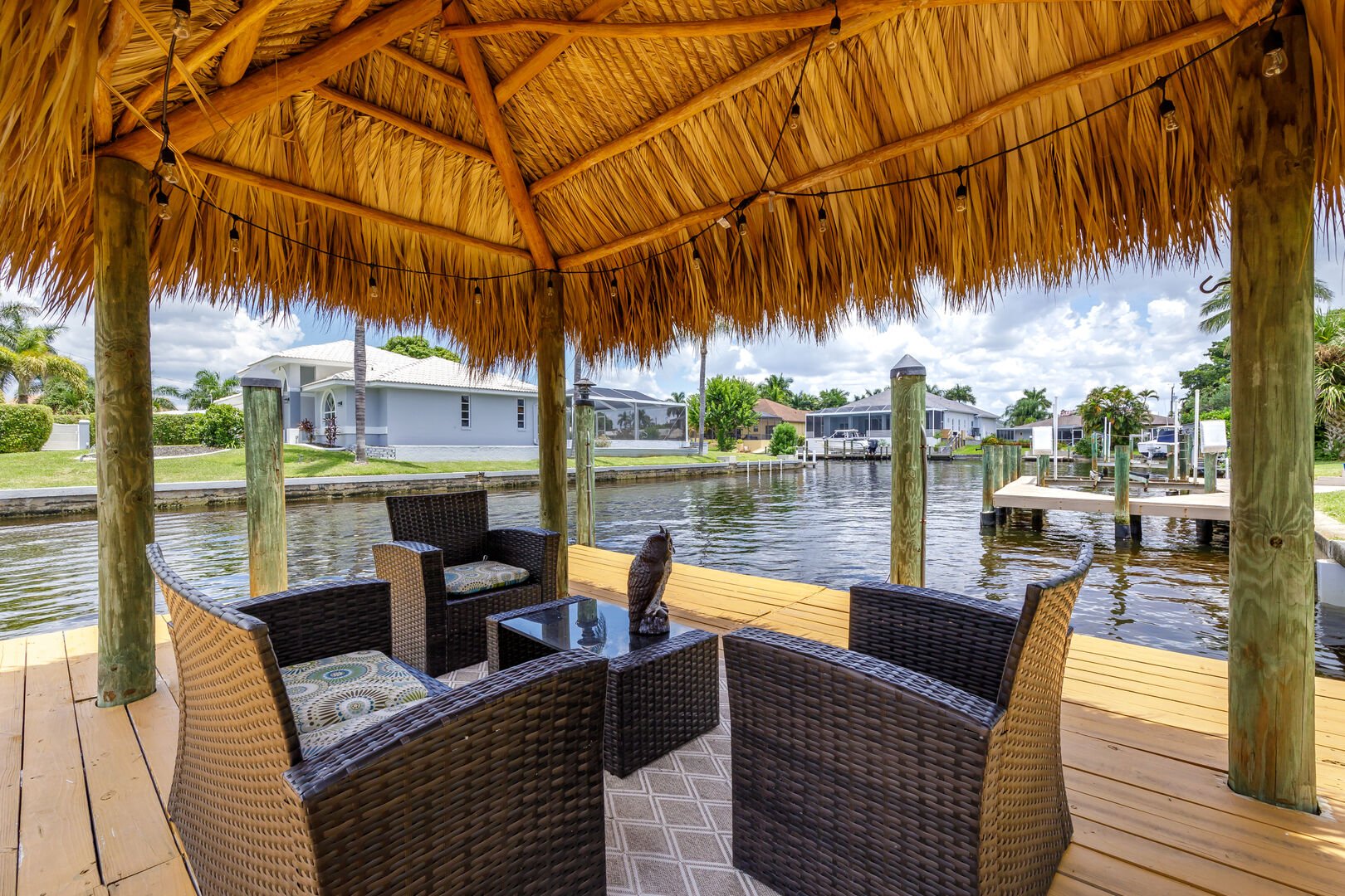 tiki hut with seating on the water