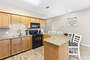 Large Size Kitchen complete with a Breakfast Bar and Granite Countertops