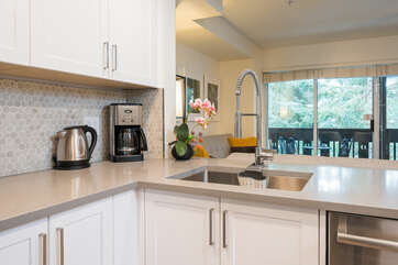 Newly renovated kitchen with stainless steel appliances and quarts countertops