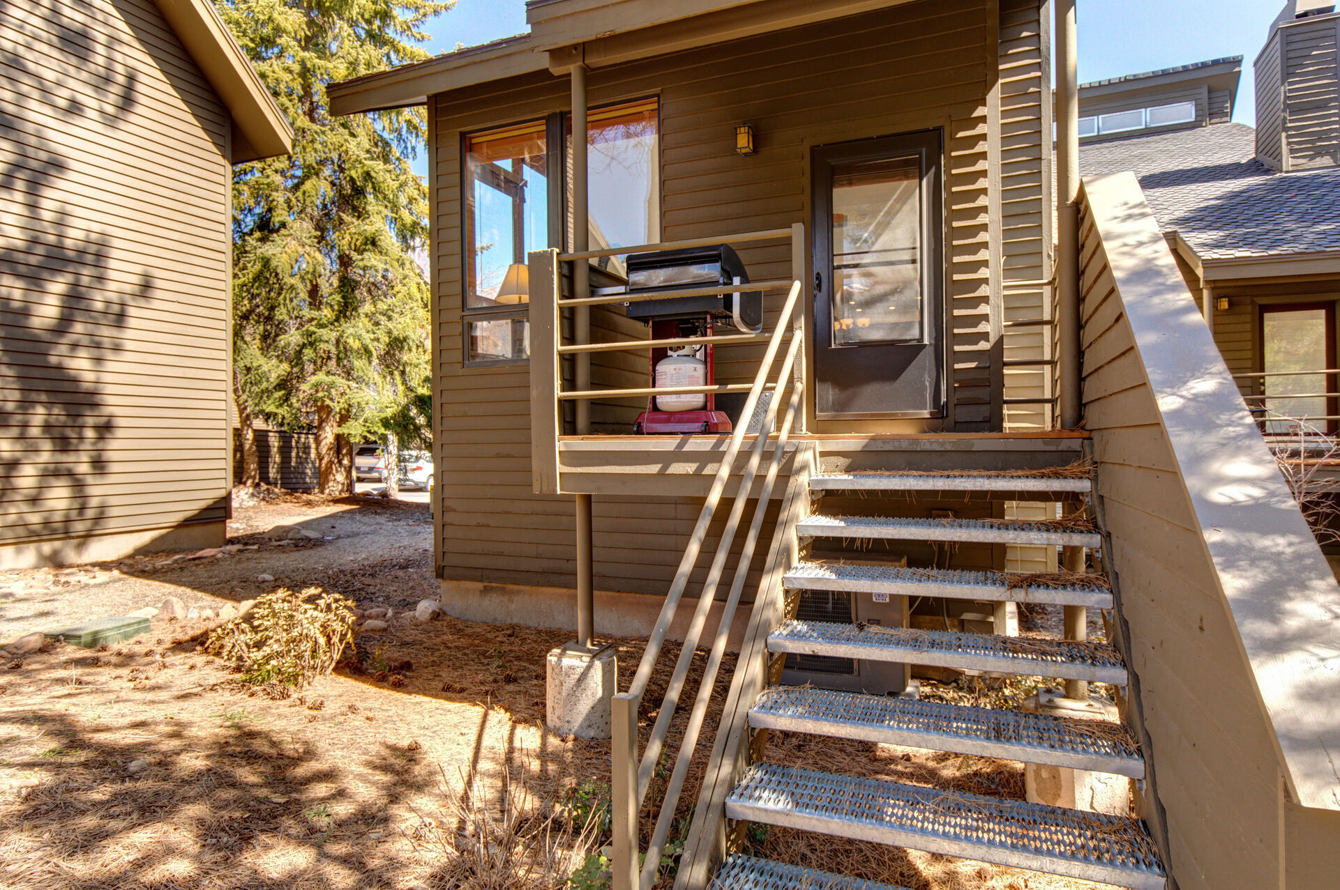 Small Private deck off living room with seating for two and bbq grill