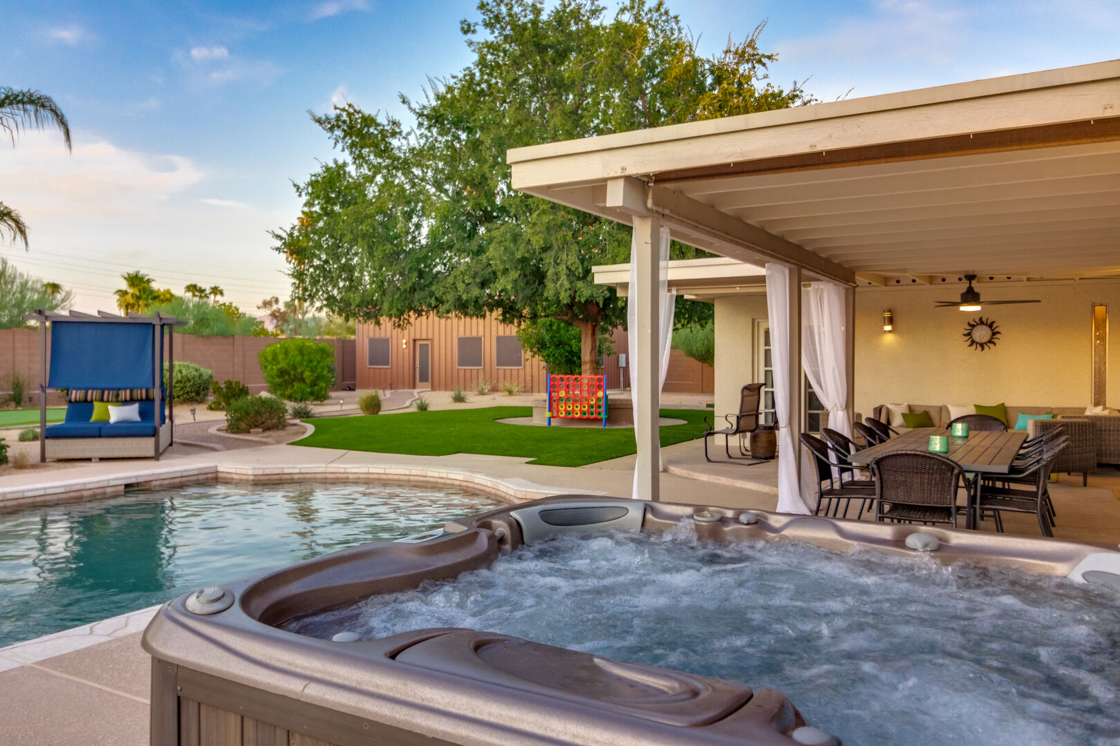 Hot Tub Overlooking Outdoor Dining Area & Pool